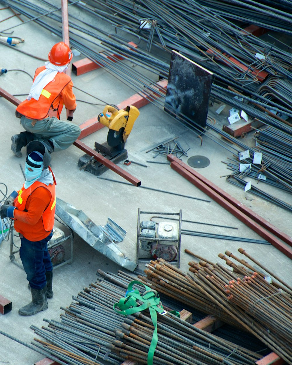 Construction site with workers and steel reinforcement